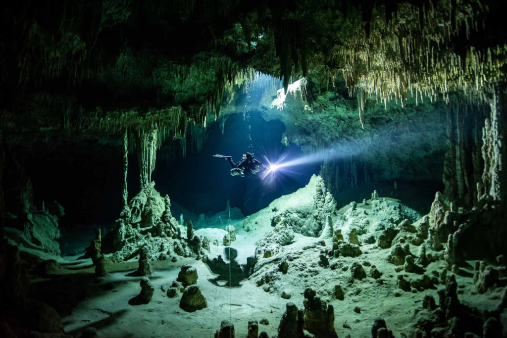 diver entering a cave