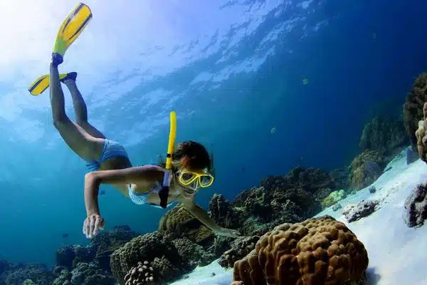 snorkeler-observing-a-rock-under-water