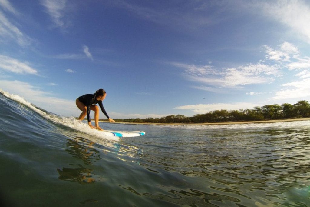 woman surfing in Avellanas beach
